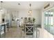 Bright dining area featuring a dining table, sliding glass doors to the patio, and decorative lighting at 1775 Copinger Ter, Kissimmee, FL 34744