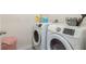 Bright laundry room features modern side by side washer and dryer units at 1775 Copinger Ter, Kissimmee, FL 34744