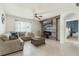 Cozy living room with a stylish accent wall, fireplace, ceiling fan, and tile flooring at 1775 Copinger Ter, Kissimmee, FL 34744