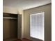 Bright bedroom features a window with blinds, a closet and hardwood floors at 1909 Caralee Blvd # 4, Orlando, FL 32822