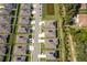 Aerial view of homes, showcasing the layout of a modern community with green spaces and street parking at 1920 Perch Hammock Loop, Groveland, FL 34736