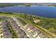 Aerial view of a neighborhood with a lake nearby, showcasing the property's location and surrounding landscape at 1920 Perch Hammock Loop, Groveland, FL 34736