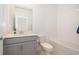 Simple bathroom featuring a single vanity, toilet, and tiled shower-tub combination at 1920 Perch Hammock Loop, Groveland, FL 34736