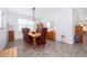 Elegant dining room with a wooden table and chairs, complemented by a modern light fixture and wood-look tile flooring at 1920 Perch Hammock Loop, Groveland, FL 34736