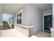 Close-up of a cozy covered front porch with stone accents and a view of the green neighborhood at 1920 Perch Hammock Loop, Groveland, FL 34736