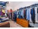 Large walk-in closet with ample storage space and an array of hanging clothes at 1920 Perch Hammock Loop, Groveland, FL 34736