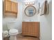 Cozy bathroom featuring wood-look tile flooring, vanity with a round mirror, and toilet at 193 Heron Bay Cir # 8, Lake Mary, FL 32746