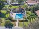 The community pool has lounge chairs and is surrounded by tropical palm trees at 193 Heron Bay Cir # 8, Lake Mary, FL 32746