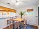 Dining area featuring a breakfast bar and large table, perfect for entertaining at 193 Heron Bay Cir # 8, Lake Mary, FL 32746