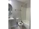 Bright bathroom with pedestal sink, oval mirror, tub and toilet, featuring classic black and white mosaic tile floor at 2025 Dixie Belle Dr # 2025 B, Orlando, FL 32812