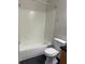 Bathroom featuring a tub and shower, toilet and neutral-colored walls. There is also a window for ventilation at 2025 Dixie Belle Dr # 2025 B, Orlando, FL 32812