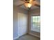 Bright bedroom featuring a ceiling fan and light fixture, a window with blinds and a closet with folding doors at 2025 Dixie Belle Dr # 2025 B, Orlando, FL 32812