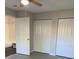 This bedroom features a bathroom and two closets with folding doors, along with a ceiling fan and light at 2025 Dixie Belle Dr # 2025 B, Orlando, FL 32812