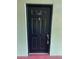View of the front door, painted black with a door knocker and the letter B above it at 2025 Dixie Belle Dr # 2025 B, Orlando, FL 32812