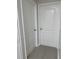 A view of two doors in a hallway with neutral-colored walls and light hardwood floors at 2025 Dixie Belle Dr # 2025 B, Orlando, FL 32812