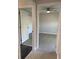 Hallway with light-colored floors and a view into a room with a ceiling fan and a door to another room at 2025 Dixie Belle Dr # 2025 B, Orlando, FL 32812