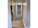 A hallway view, looking down the hallway, featuring access to the kitchen on the left at 2025 Dixie Belle Dr # 2025 B, Orlando, FL 32812