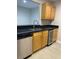The kitchen featuring stainless steel appliances, wooden cabinets, and a black countertop at 2025 Dixie Belle Dr # 2025 B, Orlando, FL 32812