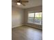 This bedroom has a window, light colored walls, and wood-look floors at 2025 Dixie Belle Dr # 2025, Orlando, FL 32812