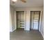 The bedroom has two closets with shelving, drawers, and clothing rods at 2025 Dixie Belle Dr # 2025, Orlando, FL 32812