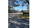 Gated entrance to the community with mature landscaping and stop sign at 2025 Dixie Belle Dr # 2025, Orlando, FL 32812