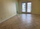 Inviting living room with tile flooring, neutral walls, and french doors leading to the patio at 204 E South St # 5058, Orlando, FL 32801