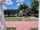 View of the yard and lush foliage from the back patio at 214 Great Yarmouth Ct, Kissimmee, FL 34758