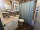 Cozy bathroom featuring a vanity with storage and a shower with a curtain at 214 Great Yarmouth Ct, Kissimmee, FL 34758