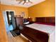 Bedroom featuring wood floors, a queen sized bed, a dresser and neutral colored walls at 214 Great Yarmouth Ct, Kissimmee, FL 34758