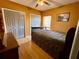 Cozy bedroom with hardwood floors, a ceiling fan, and closet space at 214 Great Yarmouth Ct, Kissimmee, FL 34758