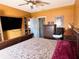 Bedroom featuring wood floors, a queen sized bed, a dresser and a TV mounted to the wall at 214 Great Yarmouth Ct, Kissimmee, FL 34758