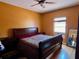 Bedroom featuring hardwood floors, a queen sized bed, neutral colored walls, and a window at 214 Great Yarmouth Ct, Kissimmee, FL 34758