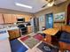 Kitchen featuring stainless steel appliances and wooden cabinets with breakfast nook at 214 Great Yarmouth Ct, Kissimmee, FL 34758