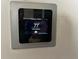 Smart thermostat displaying 77 degrees and 50% humidity inside the house at 214 Great Yarmouth Ct, Kissimmee, FL 34758