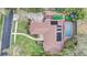 An aerial view showcasing the home's layout, pool, solar panels, backyard patio, and lush landscaping at 2227 Palm Vista Dr, Apopka, FL 32712