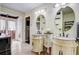 Bright bathroom with dual vanities, decorative mirrors, and tile floors leading to an outdoor entry at 2227 Palm Vista Dr, Apopka, FL 32712