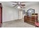 Bedroom with neutral carpet, a ceiling fan, a closet with folding doors, and a wooden dresser at 2227 Palm Vista Dr, Apopka, FL 32712