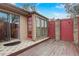 Back deck with red door and brick wall at 2227 Palm Vista Dr, Apopka, FL 32712