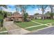 A suburban home featuring a lush green lawn and mature trees in a residential neighborhood at 2227 Palm Vista Dr, Apopka, FL 32712