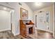 Entryway featuring wood-look tile flooring, a stylish desk, and a front door with decorative glass at 2227 Palm Vista Dr, Apopka, FL 32712