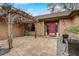 Inviting front entrance showcasing a pergola, well-maintained landscaping, and a vibrant red front door at 2227 Palm Vista Dr, Apopka, FL 32712