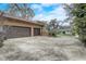 Three-car garage with a concrete driveway and a well-maintained landscape providing a secure parking area at 2227 Palm Vista Dr, Apopka, FL 32712