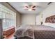 Primary bedroom featuring a large window, wood floors, a fan, and a dresser with a wall mounted TV at 2227 Palm Vista Dr, Apopka, FL 32712