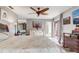 Relaxing main bedroom featuring a ceiling fan, light gray walls and access to an outdoor patio at 2227 Palm Vista Dr, Apopka, FL 32712