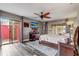 A primary bedroom with a ceiling fan, a wall-mounted TV, and sliding glass doors to the outdoor area at 2227 Palm Vista Dr, Apopka, FL 32712