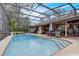 Screened-in backyard swimming pool with stairs and exterior living space at 2227 Palm Vista Dr, Apopka, FL 32712