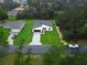 Aerial shot of a single-story home with manicured lawn on a tree-lined street at 2246 Sw 167Th Pl, Ocala, FL 34475