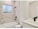 Elegant bathroom featuring marble-style tile, sleek fixtures, and a bright, frosted window at 2246 Sw 167Th Pl, Ocala, FL 34475