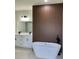 Elegant bathroom features double vanity, modern fixtures, and a freestanding soaking tub in a stylish setting at 2246 Sw 167Th Pl, Ocala, FL 34475