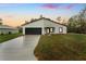 Charming single-story home featuring a dark garage door and modern architectural details at 2246 Sw 167Th Pl, Ocala, FL 34475